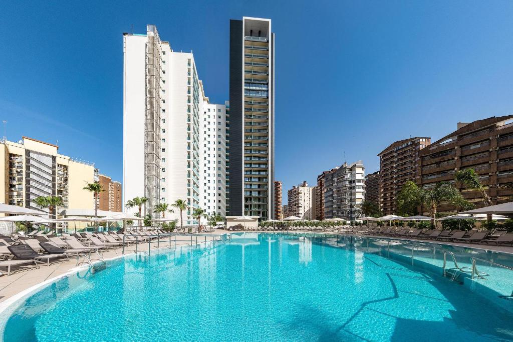 a large swimming pool in a city with buildings at Port Benidorm Hotel & Spa 4* Sup in Benidorm