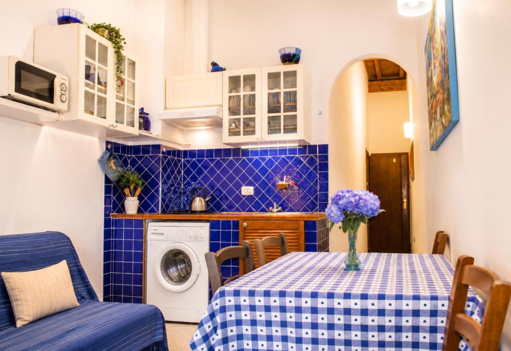 a kitchen and dining room with a table and a washing machine at Max Studios Florence in Florence