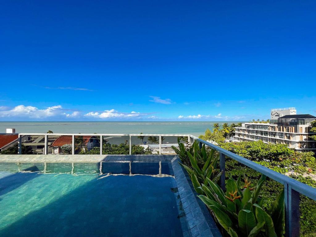 a view of the ocean from the balcony of a resort at Way Bossa in João Pessoa