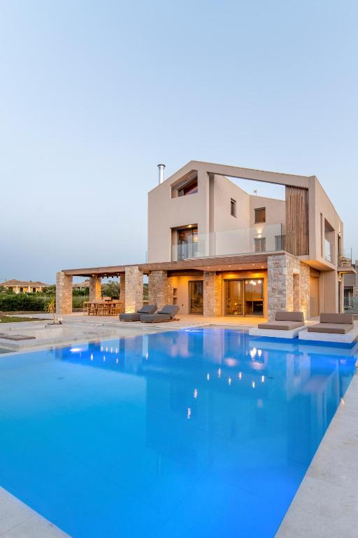 a large swimming pool in front of a house at The Retreat Villa in Lefkada