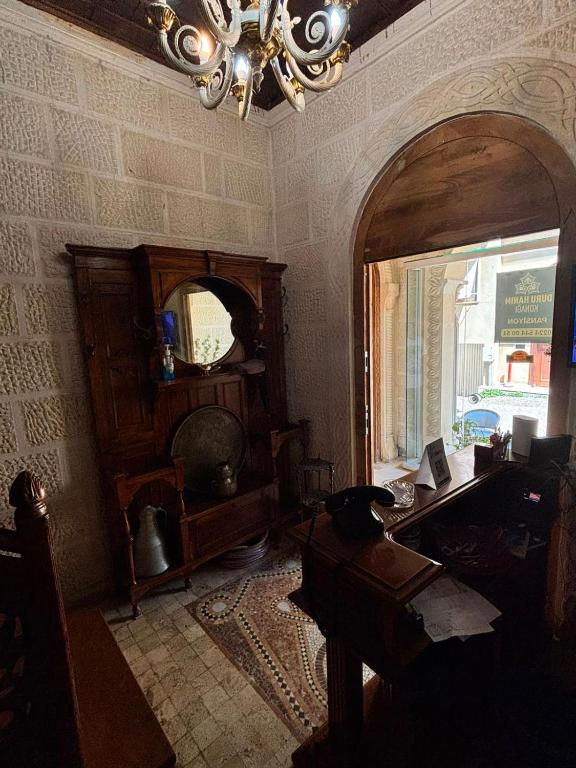 a room with a desk and a window and a chandelier at Duru Hanım Konağı in Bursa