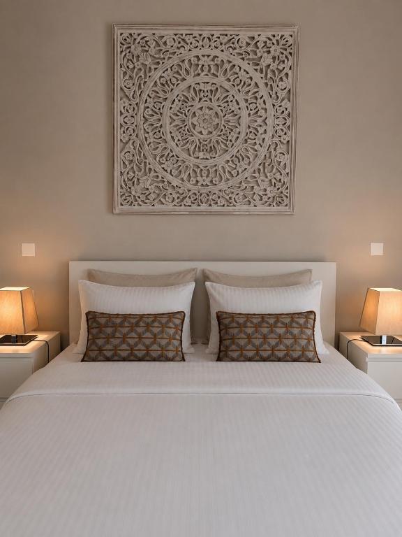 a bedroom with a white bed with two pillows at Angoli di pace - Appartamento trilocale in Muralto