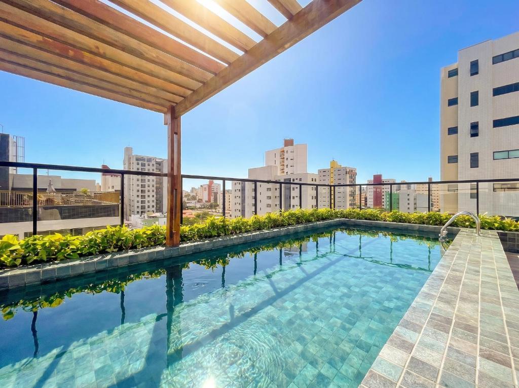 a swimming pool on the roof of a building at Hub by Hosppedar in Cabedelo