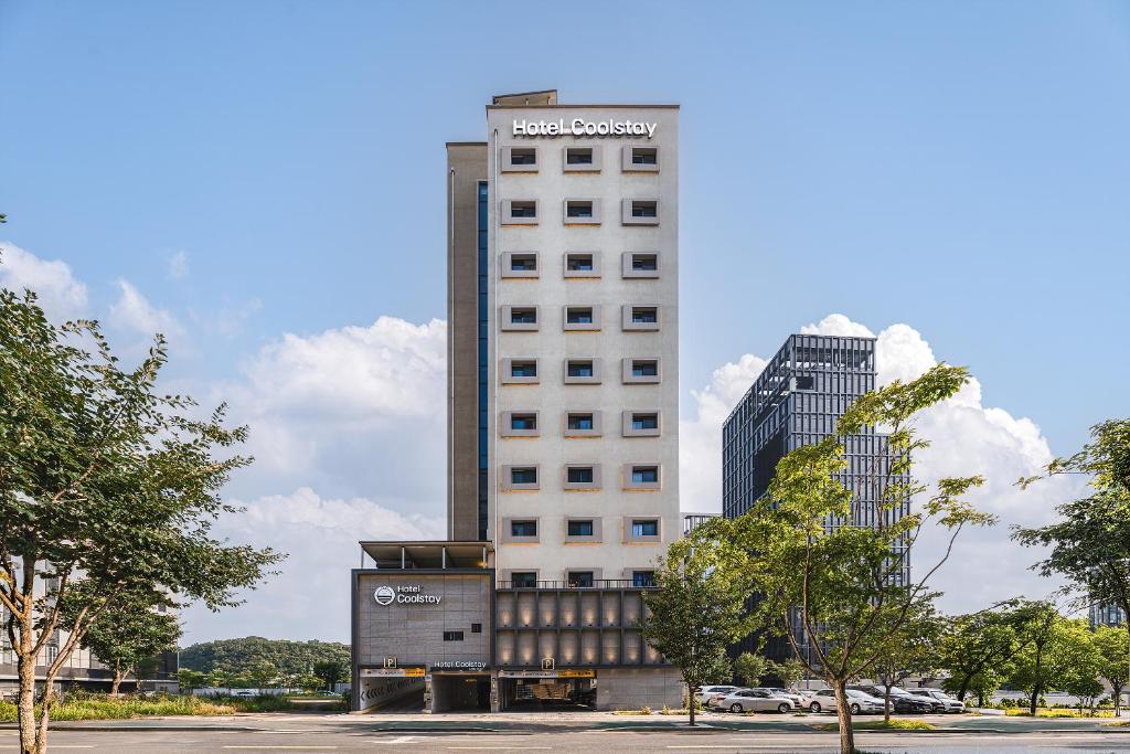 a tall white building with a sign on it at Hotel Coolstay Lions Park Daegu February Hotel Lions Park in Daegu
