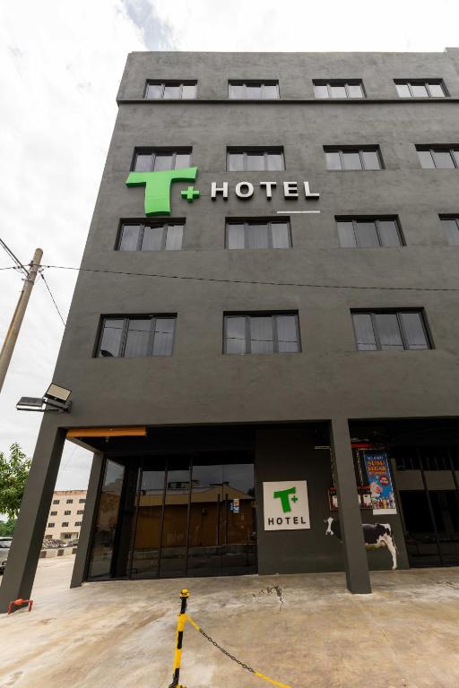 a t hotel building with a sign on it at T Hotel SP Pekan Lama in Sungai Petani