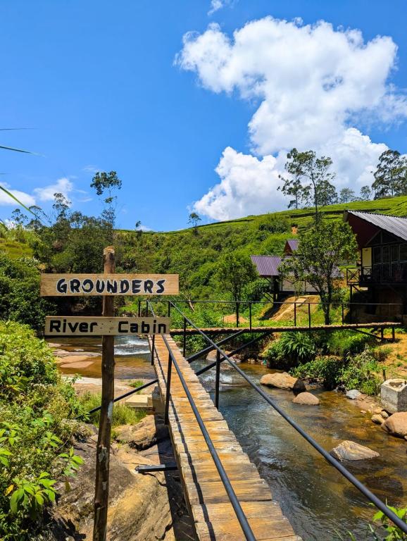 a sign that reads grouppers river camp next to a stream at Grounder's River Cabin in Nanu Oya