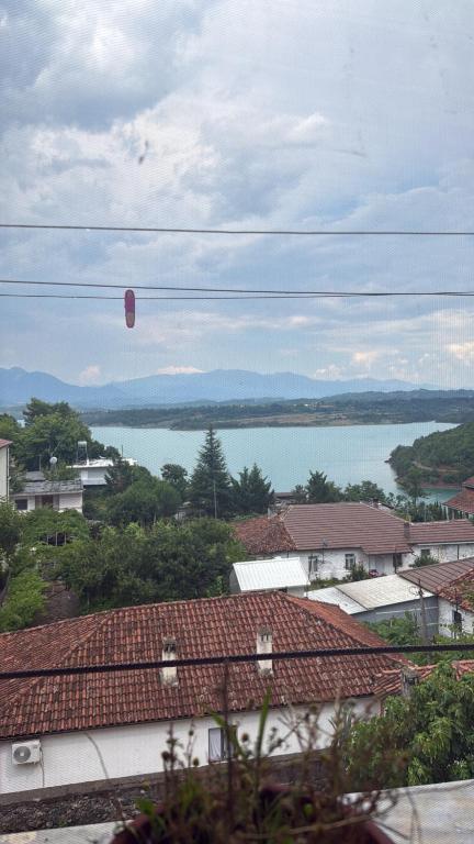 a hot air balloon flying over a city at Ulëz Nature Apartment in Ulëz