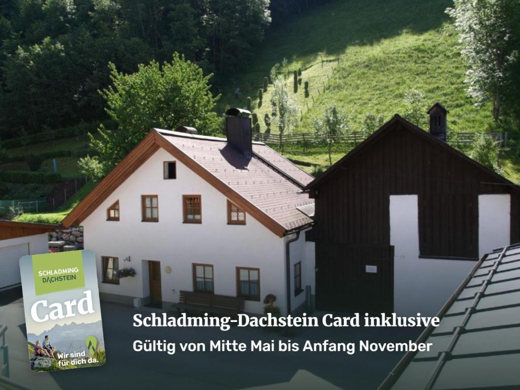 a white house with a black roof at Simonegg in Schladming