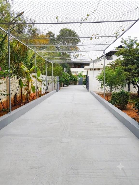 an empty walkway in a building with trees at Hidden Heaven Villa in Puducherry Airpoert