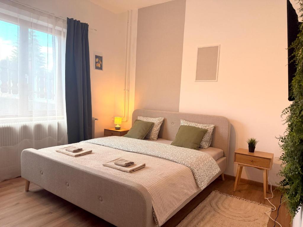 a bedroom with a bed and a couch and a window at Apartments Chloe - Top 5 in Hollabrunn