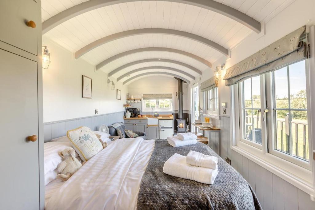 a bedroom with a large bed with towels on it at 1 Bed in Beaworthy oc-93267 in Ashwater