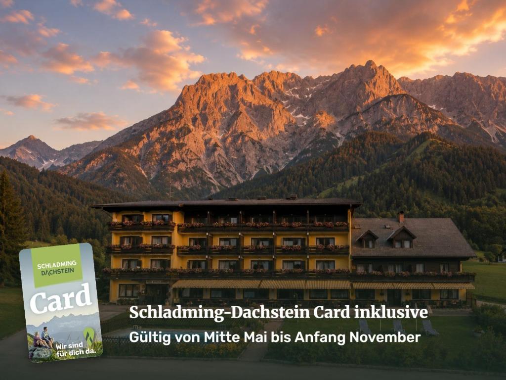 a rendering of a hotel with mountains in the background at Ferienhotel Knollhof in Ramsau am Dachstein