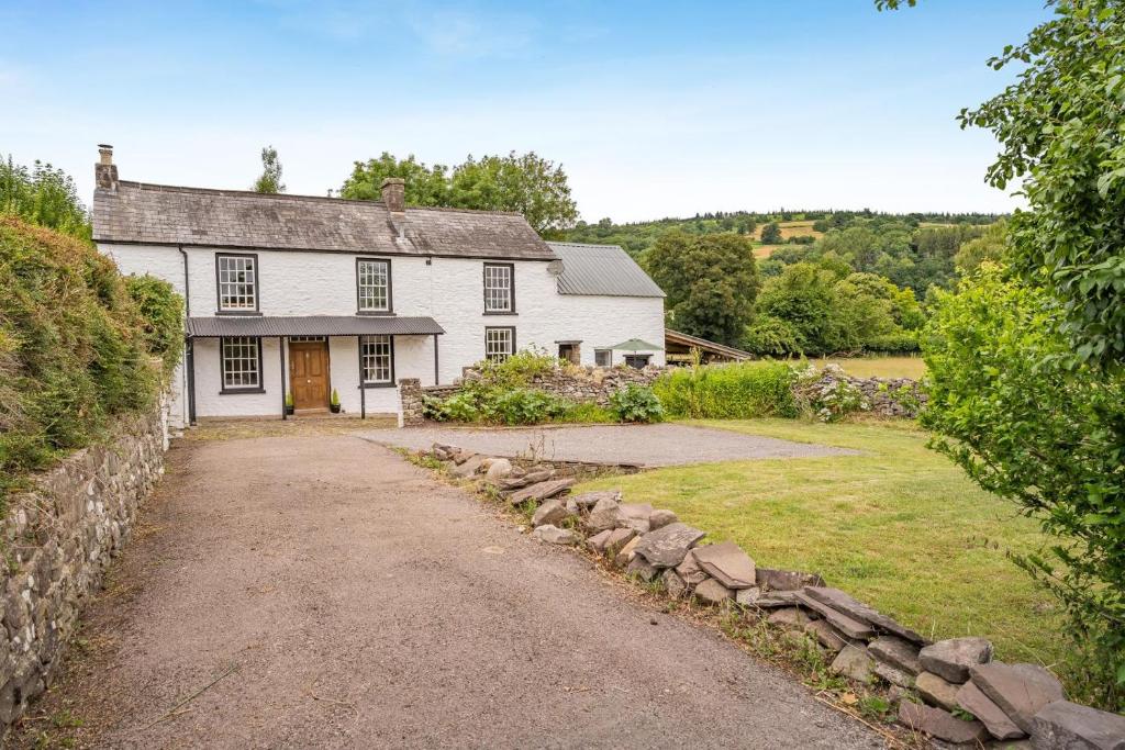 a white house with a driveway in front of it at 2 Bed in Llangynidr oc-l31914 in Llangynidr