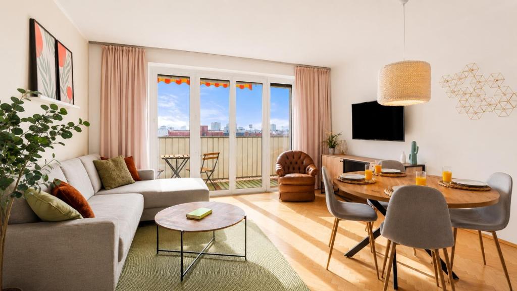 a living room with a couch and a table at Zentral und Ruhig am Park - 2BR - gratis Parken - 2 Balkone in Graz