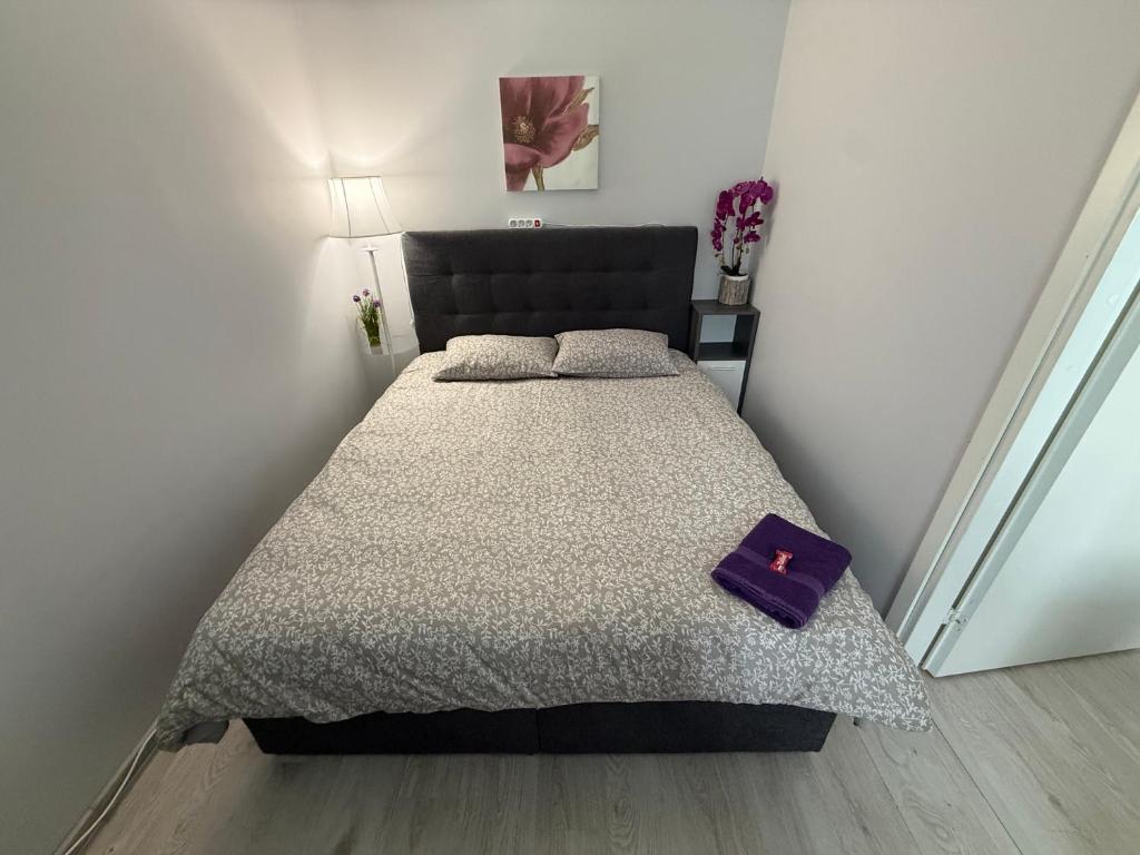 a bedroom with a bed with a purple book on it at Tallinn Randla 14 in Tallinn