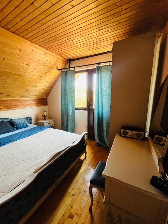 a bedroom with a large bed and a window at Meandri Ćehotine in Pljevlja