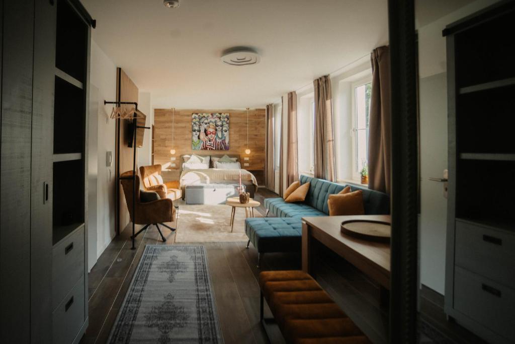 a living room with a blue couch and a bed at Villa Medicus in Dessau