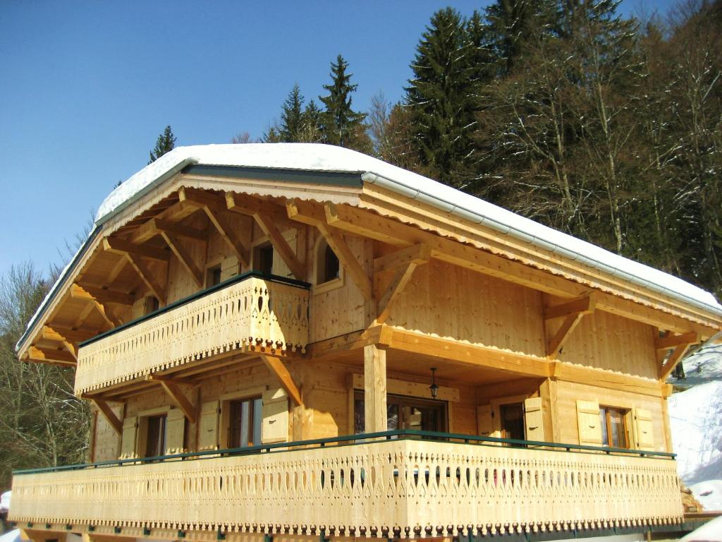 a large wooden house with snow on the roof at Riders Refuge - Chalet Eterle in Morzine