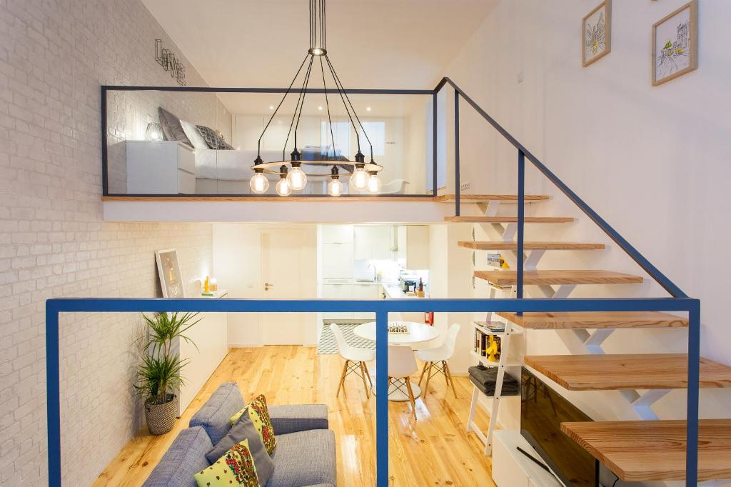 een loft met een trap en een woonkamer bij Modern Loft in Bica -JJ Apartment's in Lissabon