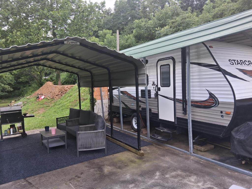an rv parked next to a grill and a piano at Camper with Queen and bunk bed in Robbinsville