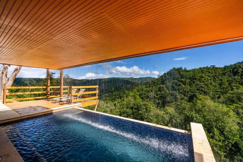 a swimming pool with a view of the mountains at Casa Brisa with Heated Pool Mountain View & River in Las Marias