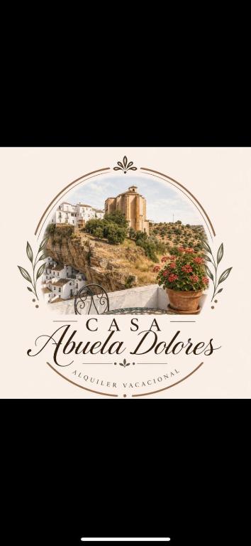a sign for a hotel bathroom with a picture of a building at Casa Abuela Dolores in Setenil