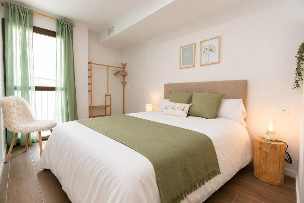 a bedroom with a large bed and a window at Xena Abeto by BeValle in Panticosa