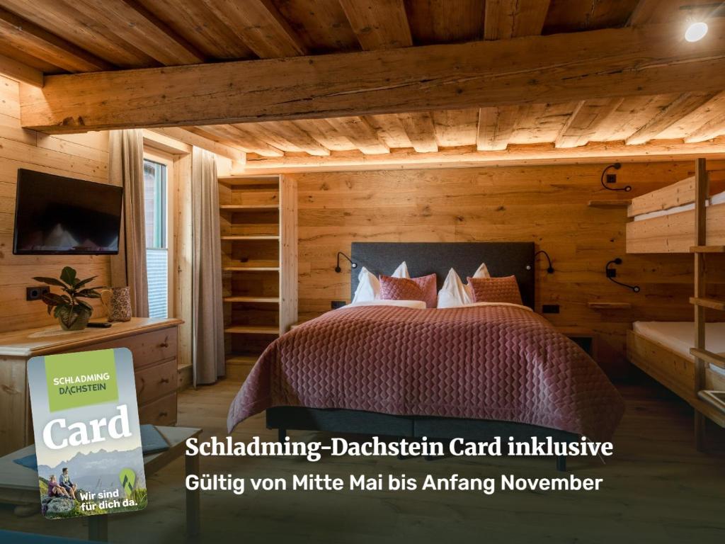 a bedroom in a log cabin with a bed at Das kleine Bio Hotel Tiefenbach in Schladming