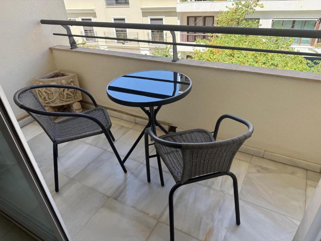 a patio with two chairs and a table on a balcony at Gilarez in Estepona