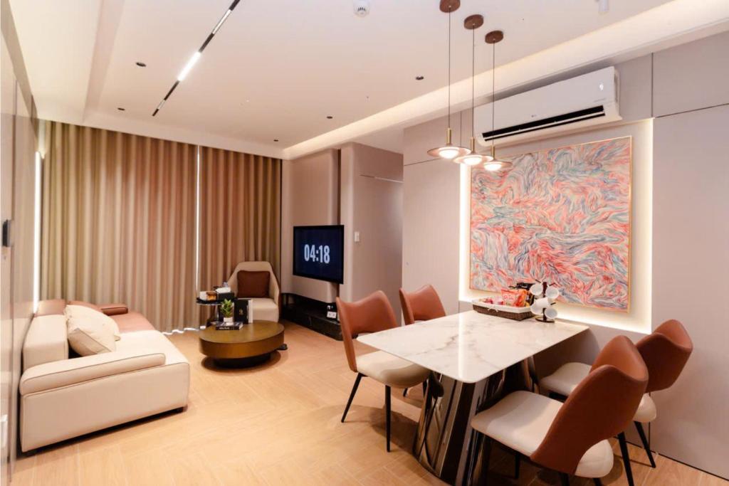 a living room with a table and chairs and a couch at The Pathway Sầm Sơn in Sầm Sơn