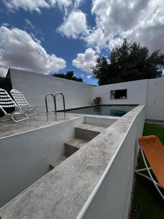 a swimming pool on the roof of a house at Juniors Country House in Vila Boim