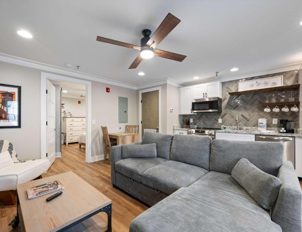 a living room with a couch and a ceiling fan at Carters Court Cozy Hideaway in Franklin