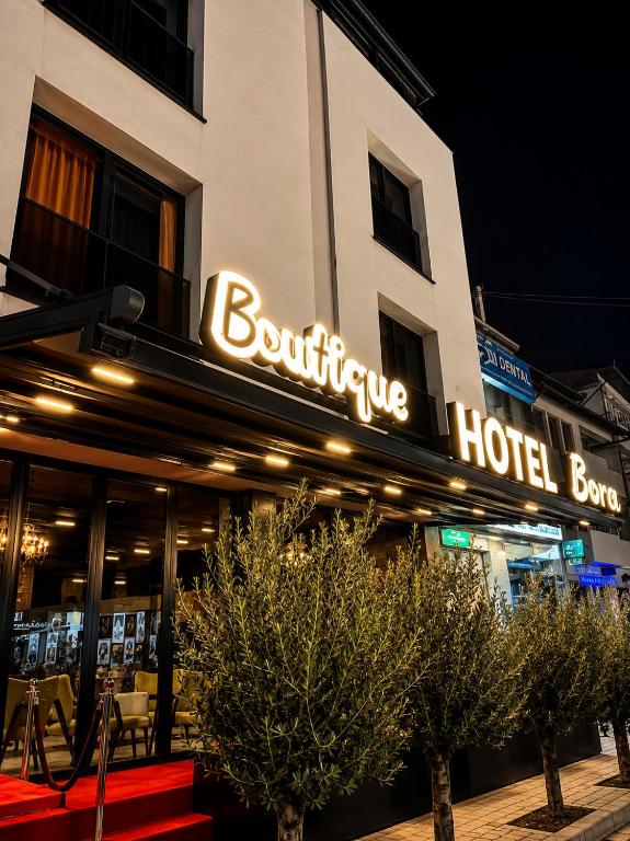 a hotel building with a sign on the front of it at Boutique Hotel Bora in Peje