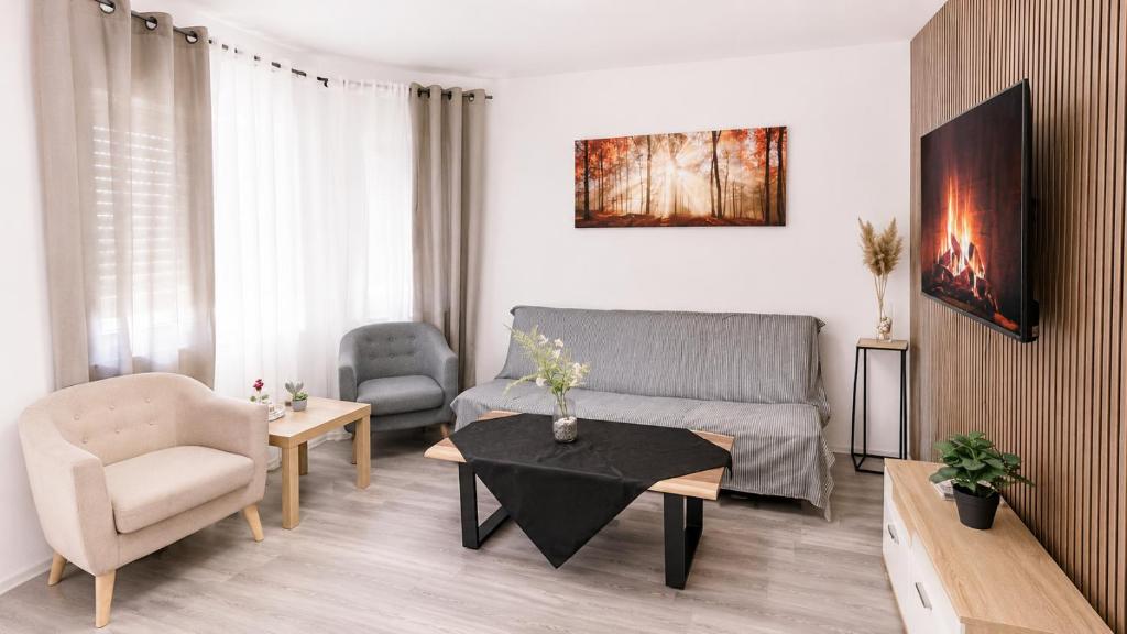 a living room with a couch and a table at Gartenparadies mit Rheinblick in Urbar in Urbar