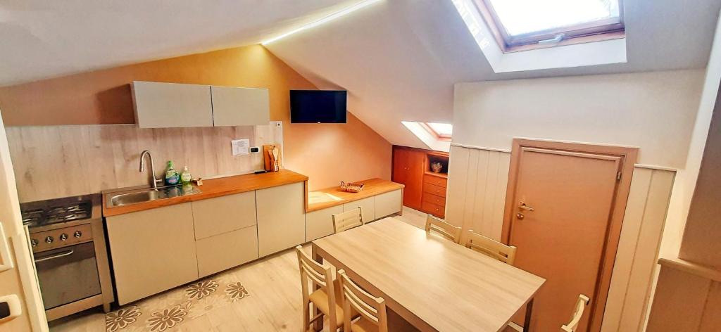 a kitchen with white cabinets and a skylight at Casa di Giò in Capracotta