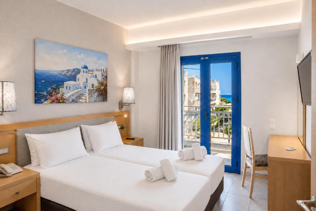 a hotel room with a bed and a window at Sergiani Garden Hotel Apartments in Stalís
