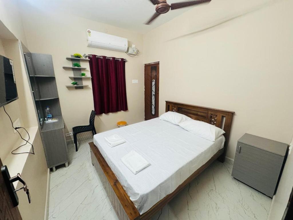 a bedroom with a bed and a television in it at Kavitha Residency in Virudunagar