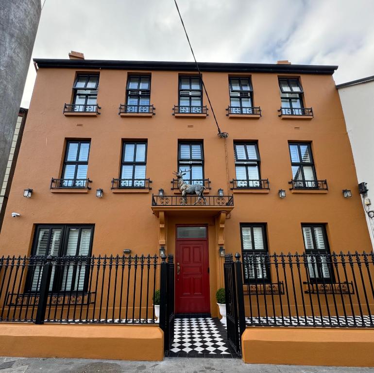 a orange building with a red door at the Continental Boutique Residence in Galway