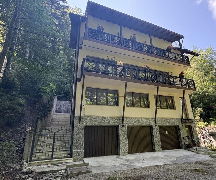 a building with a balcony with people on it at Casa Sf Nicolae in Sinaia