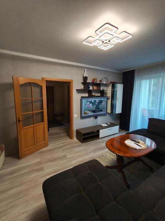 a living room with a couch and a table at Weekend Home in Visaginas