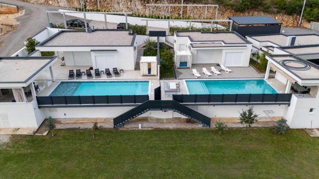 an aerial view of a house with a swimming pool at Villas Magnolia in Blagaj