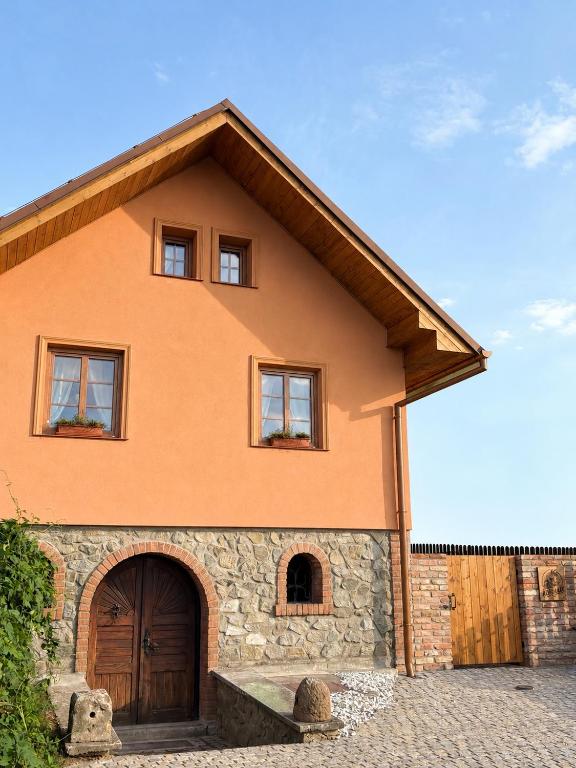 a house with a large door and a stone at Kokodáák in Troskotovice