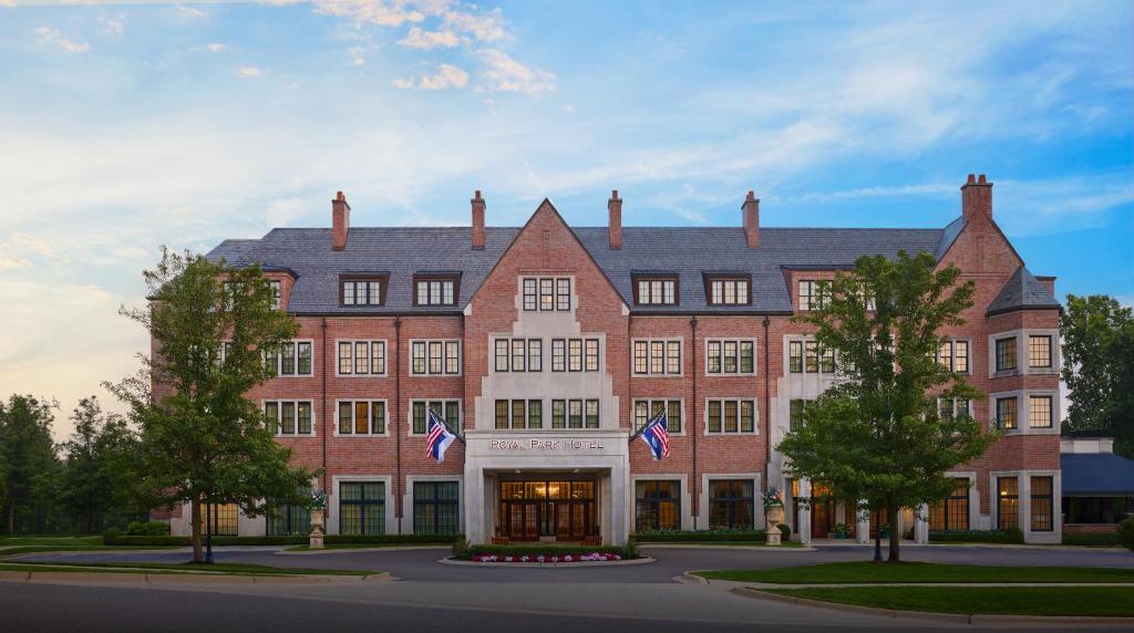a large brick building with flags in front of it at Royal Park Hotel in Rochester