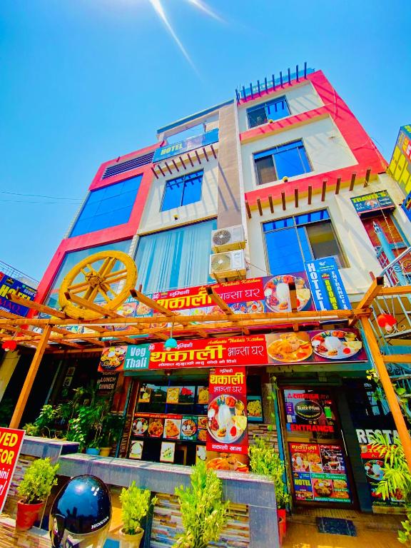 a building with signs on the side of it at Hotel MAQ Lumbini in Rummindei