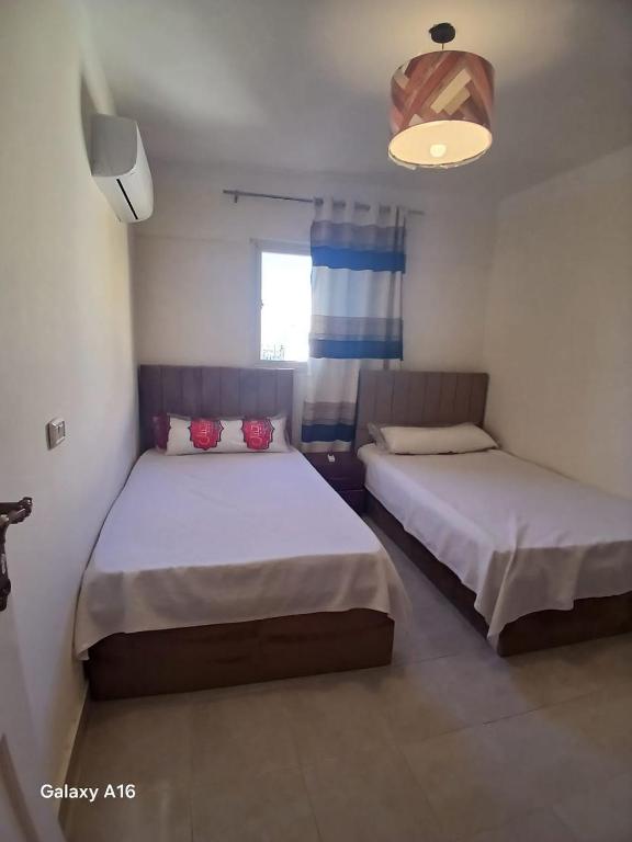 a bedroom with two beds and a window at dalina resort in El Alamein