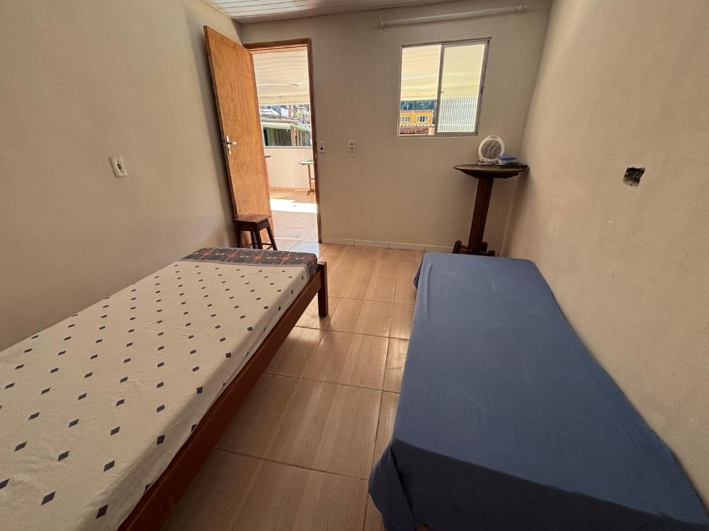 a room with two beds and a hallway at BECO 6 house in Petrópolis