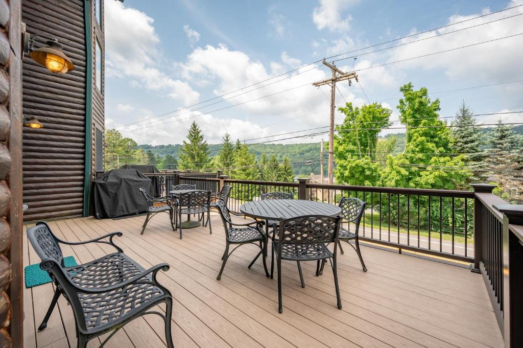 a patio with tables and chairs on a deck at Cedar Shores Villa #08 by Railey Vacations in McHenry