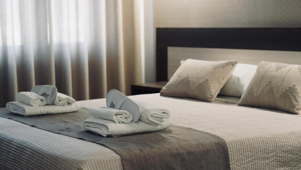 two beds with folded towels on them in a hotel room at Mini B&B - Alessandro Volta in Rende