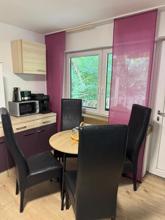 a kitchen and dining room with a table and chairs at BaumTraum in Fürthen