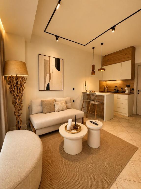 a living room with a couch and a table at Noema Park View in Xanthi